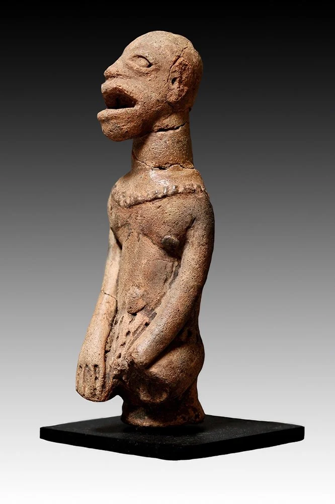 Koma terra-cotta figure with hands resting on torso.  www.gallerytribalart.com