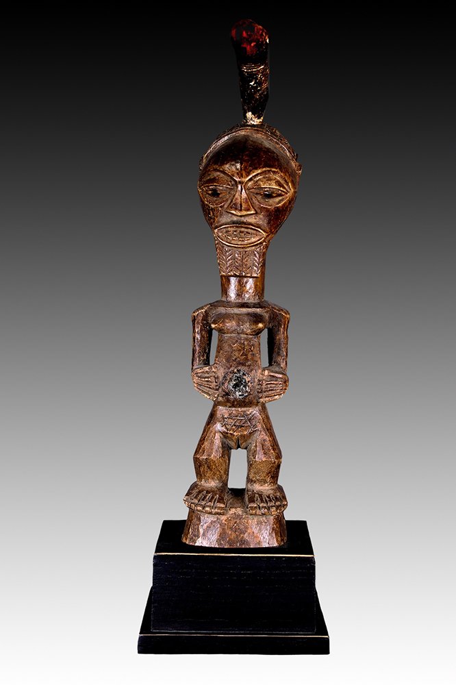 Songye figure with glass in the abdominal cavity.  www.gallerytribalart.com