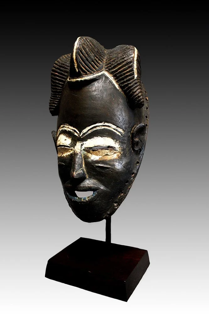 Bete Guro mask has arching brows, elliptical eye slits and kaolin pigment.  www.gallerytribalart.com