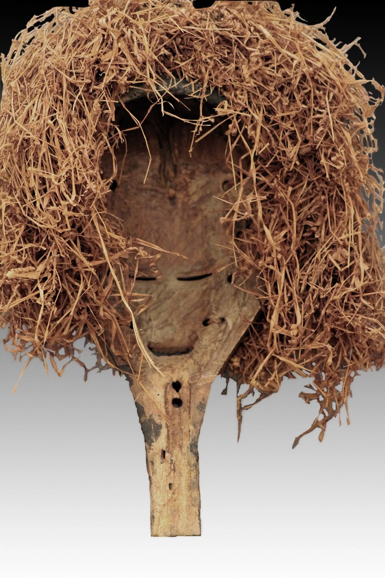 Yaka headdress back view, showing raffia and handle.  www.gallerytribalart.com