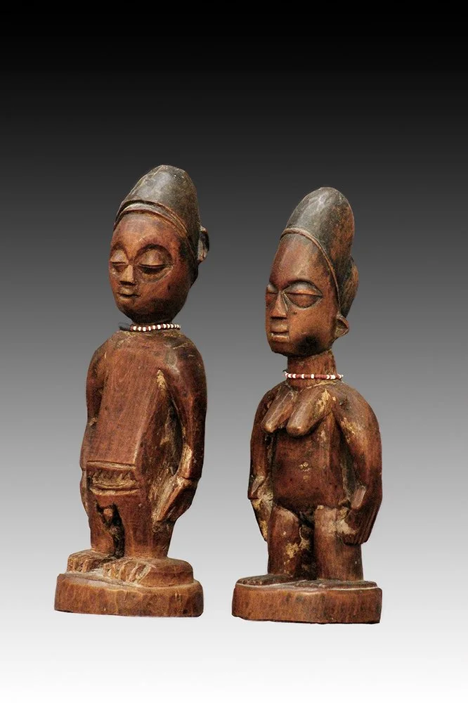 Yoruba Ibeji pair with reddish brown patina.  www.gallerytribalart.com