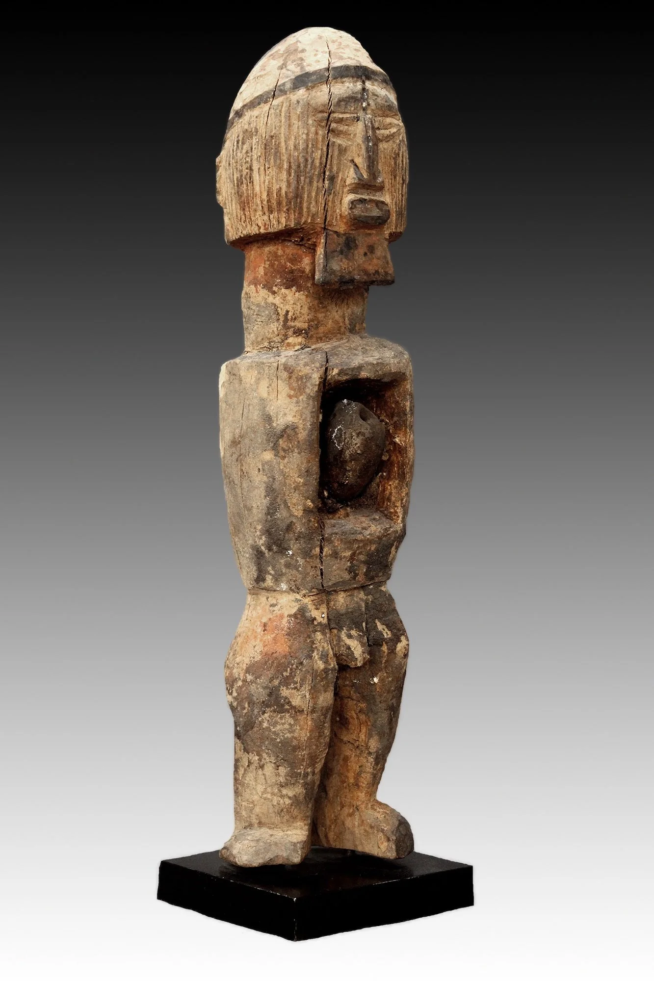 The Teke figure has an encrusted patina and bent legs supporting a rectangular torso with hollowed abdominal cavity.  www.gallerytribalart.com