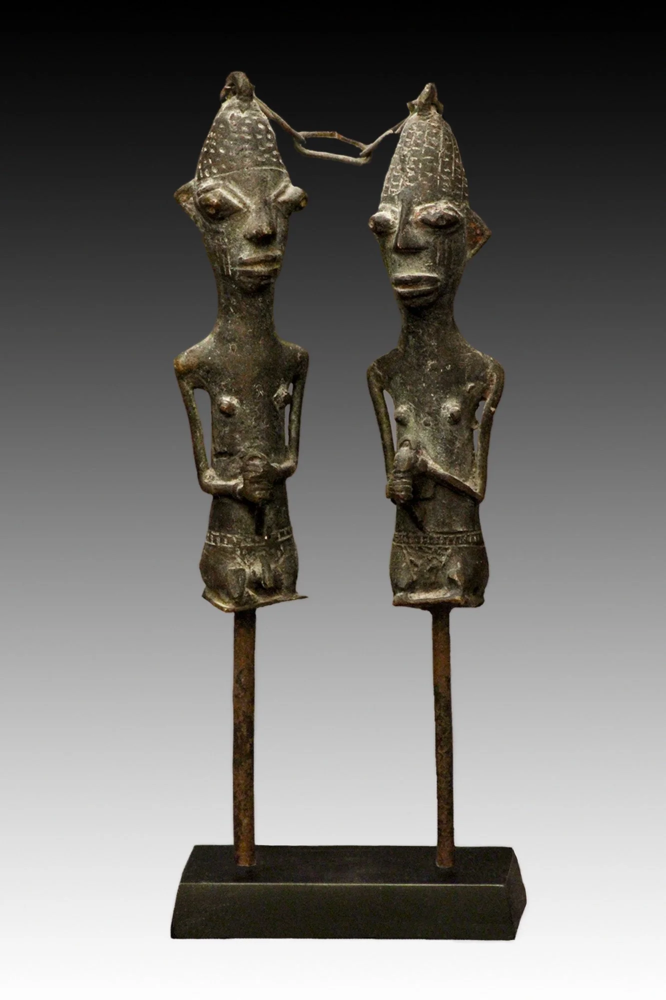 Ogboni Edan Figures are brass castings placed on iron shafts and joined by a chain.  www.gallerytribalart.com