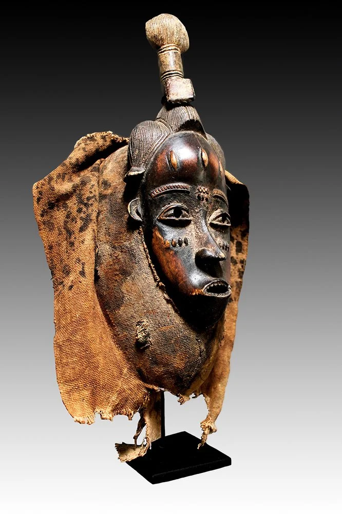 Guro mask with braided hair forming a topknot.  www.gallerytribalart.com