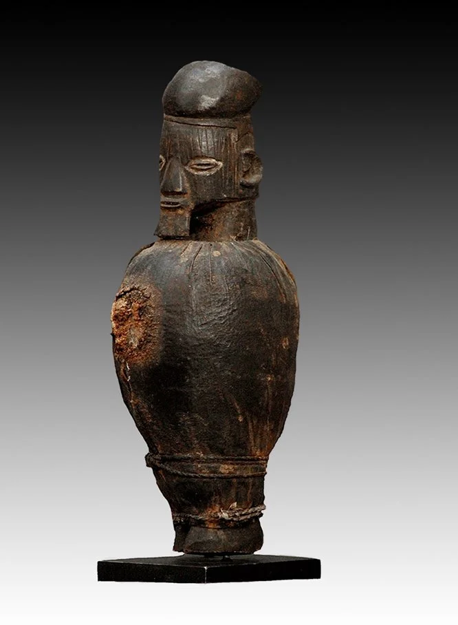 Teke figure with coffee-bean eyes, triangular nose, slit mouth and short beard.  www.gallerytribalart.com