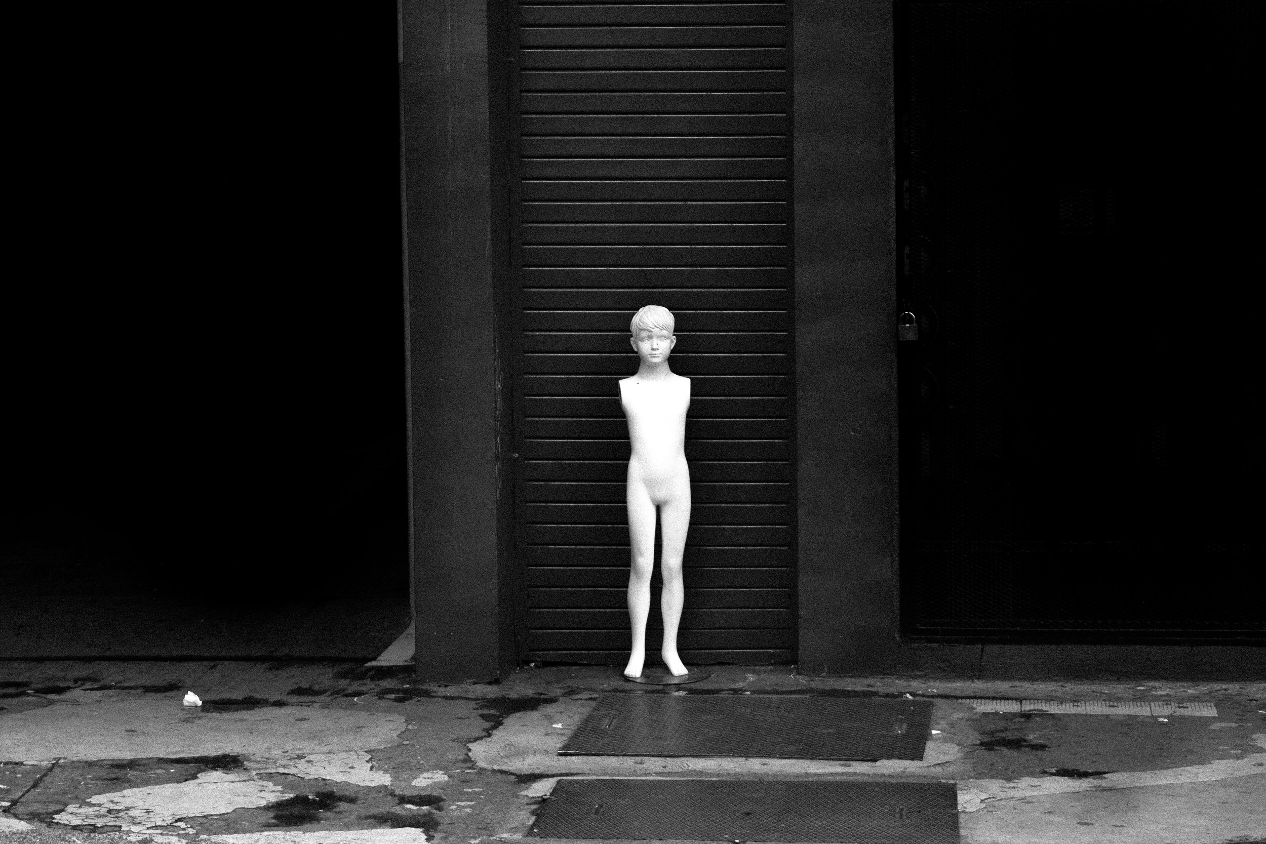 An amrless mannequin kid left abandoned.