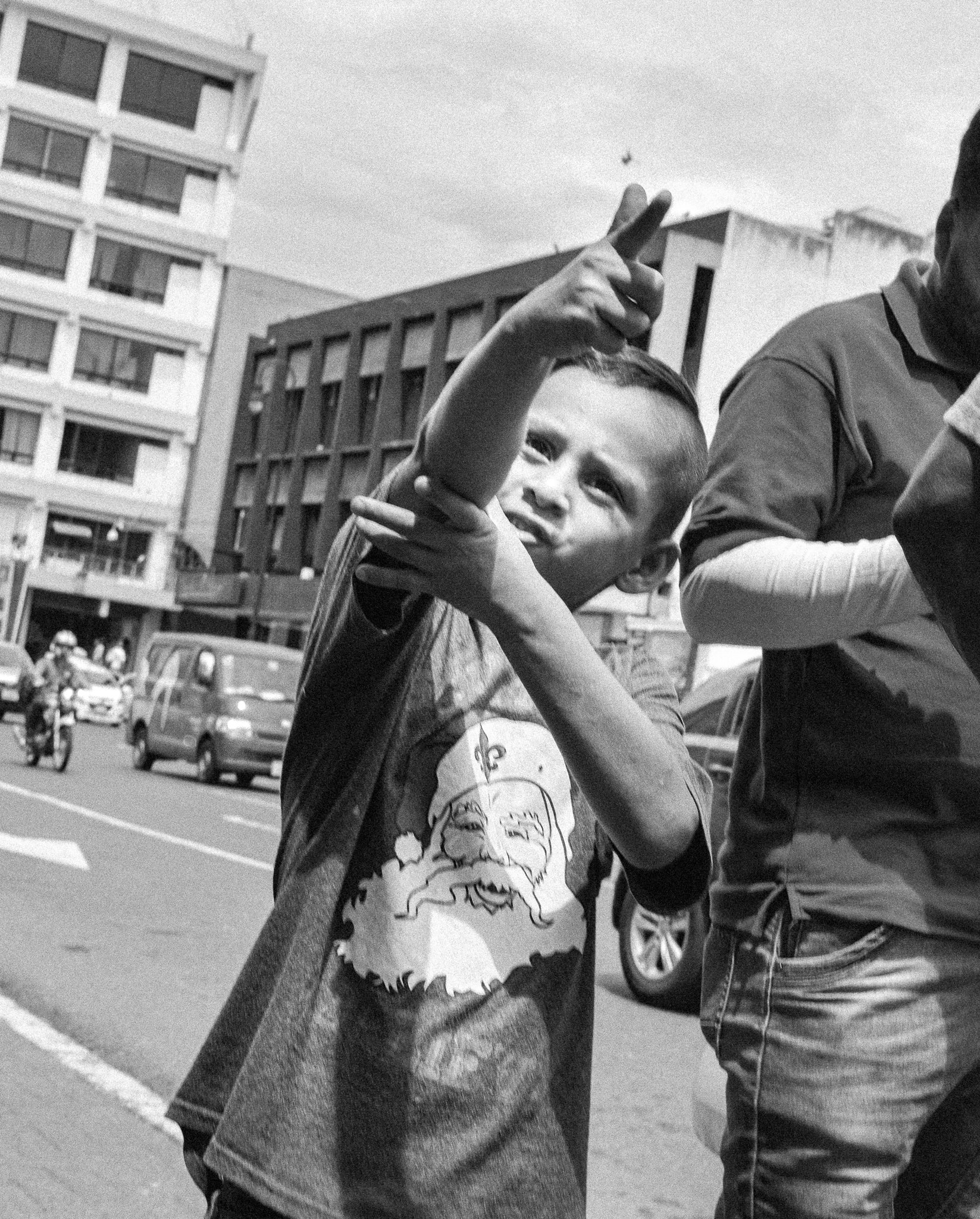 A kid throwing gun signs at the camera.