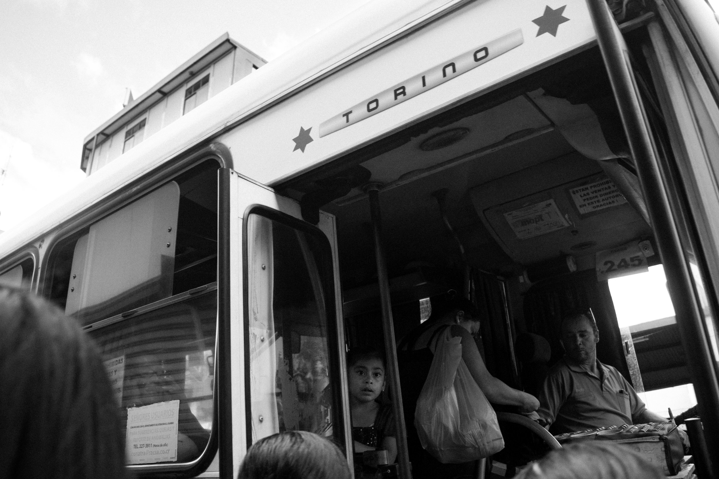 A little girl requests to go down on a bus stop.