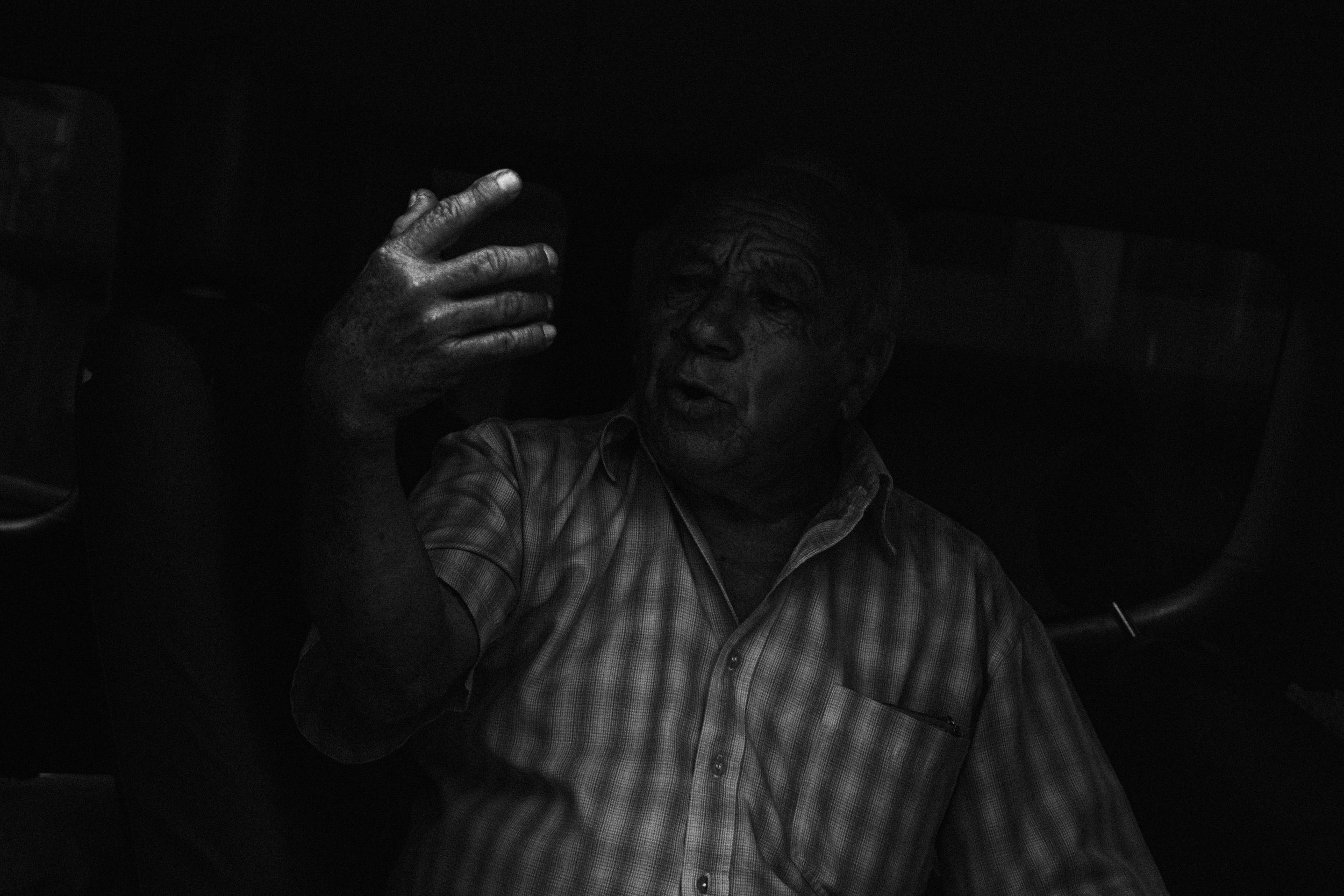 An elder speaking with the paramedics inside an ambulance parked outside the San Juan de Dios hospital.