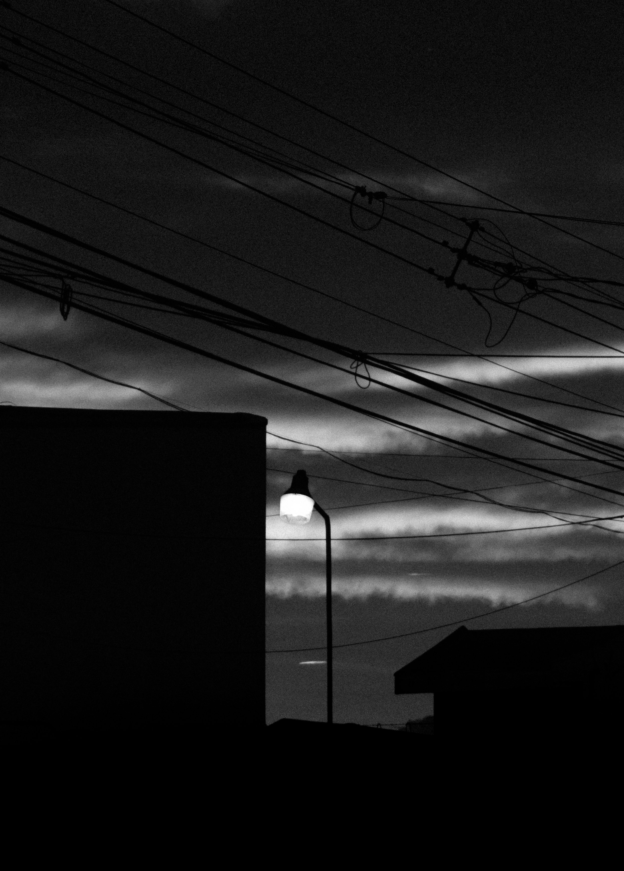 A lamp post lighting the incoming night at a park in Curridabat.