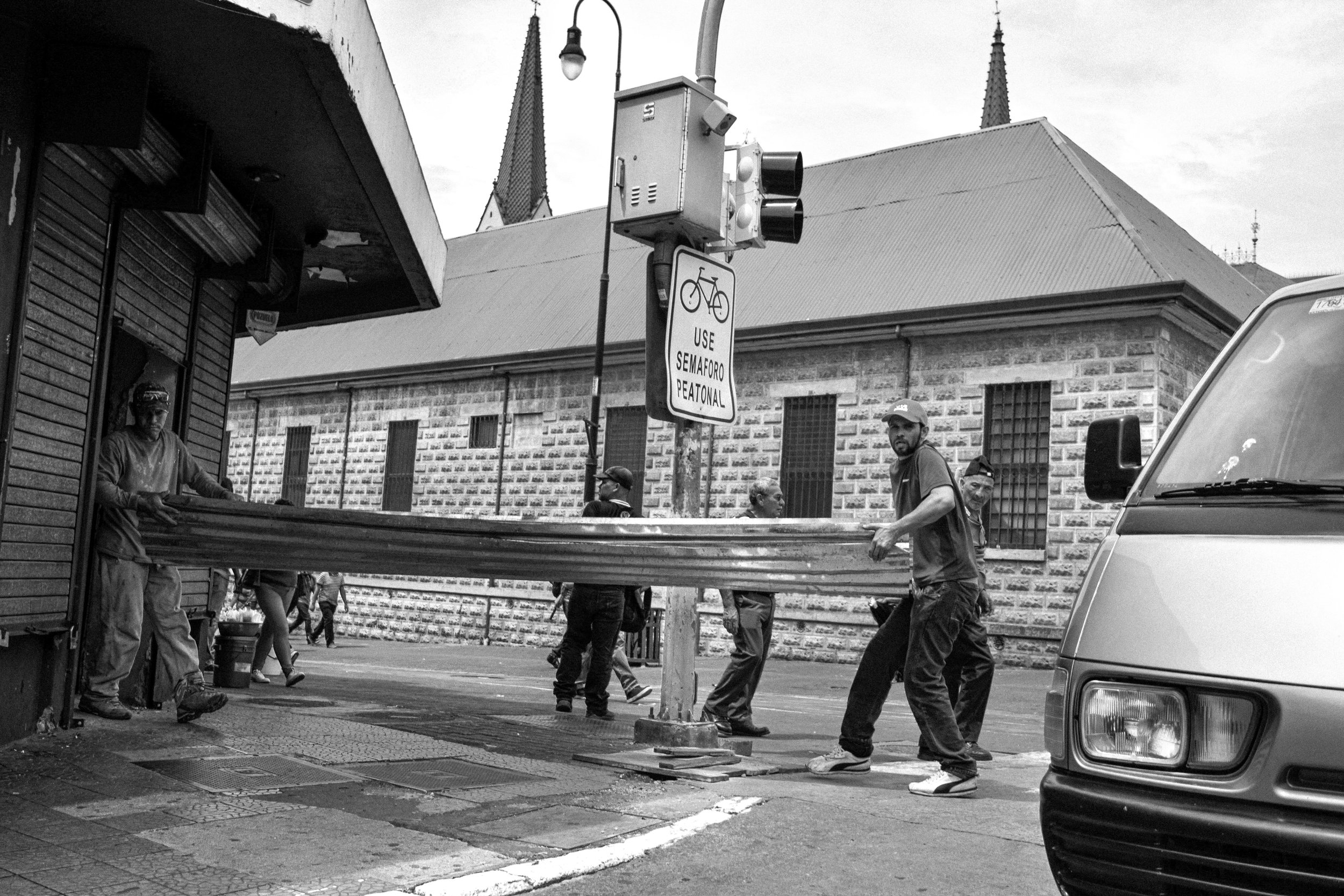 Workers moving their tools into their transportations.