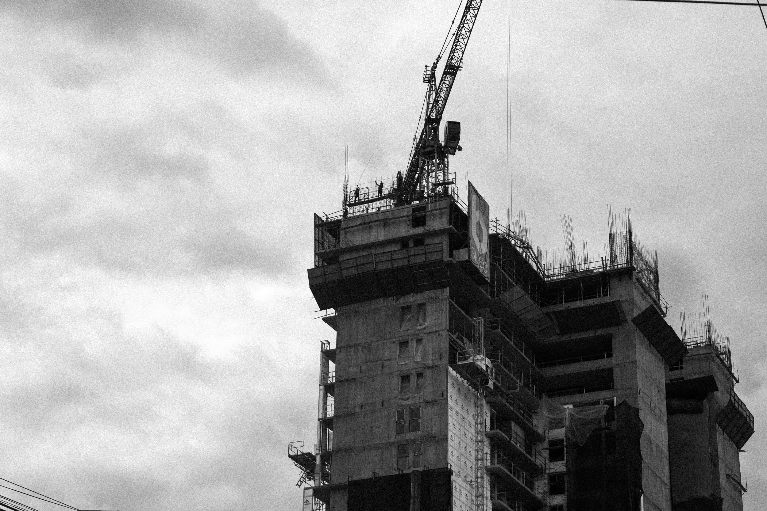 Construction personnel working on one of the towers at a soon-to-be residential building near los Yoses in SJ center.