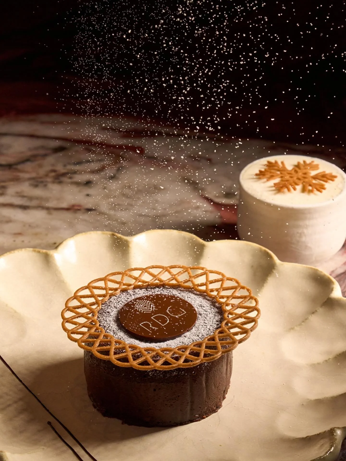 Celebrate the magic of Christmas with our signature Chocolate Lava Cake paired with silky Tahitian vanilla ice cream, crowned with a delicate snowflake coconut tuile. A festive indulgence crafted for moments worth savoring available exclusively at ou