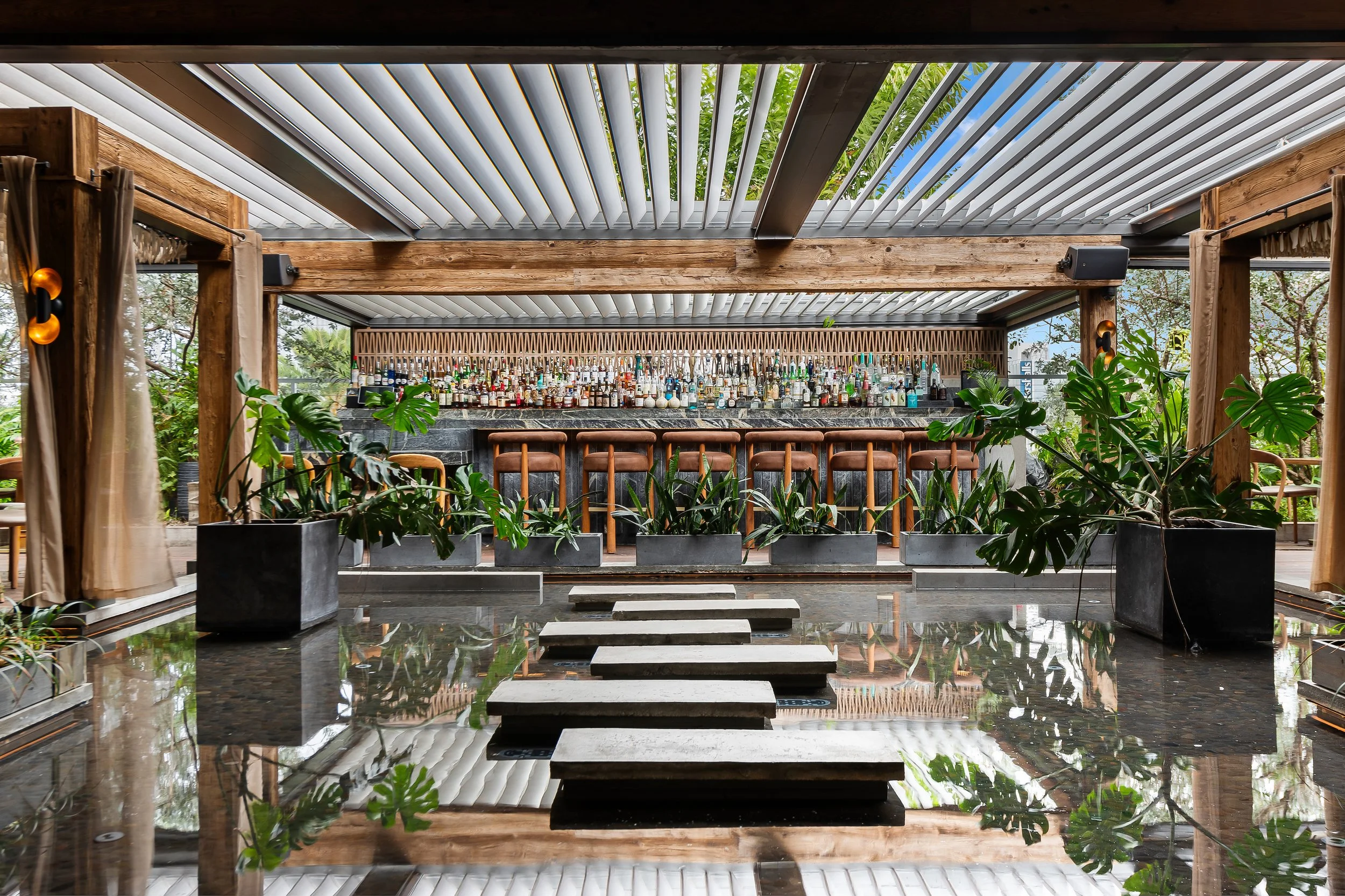 MILA's outdoor rooftop dining area, with a bar in the back.