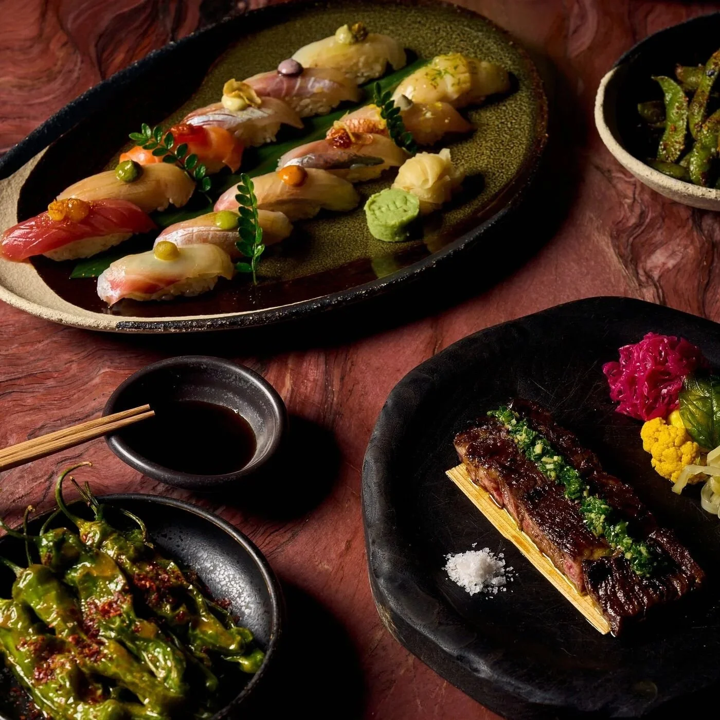 Some of MILA's menu items, including the skirt steak and a sushi platter.