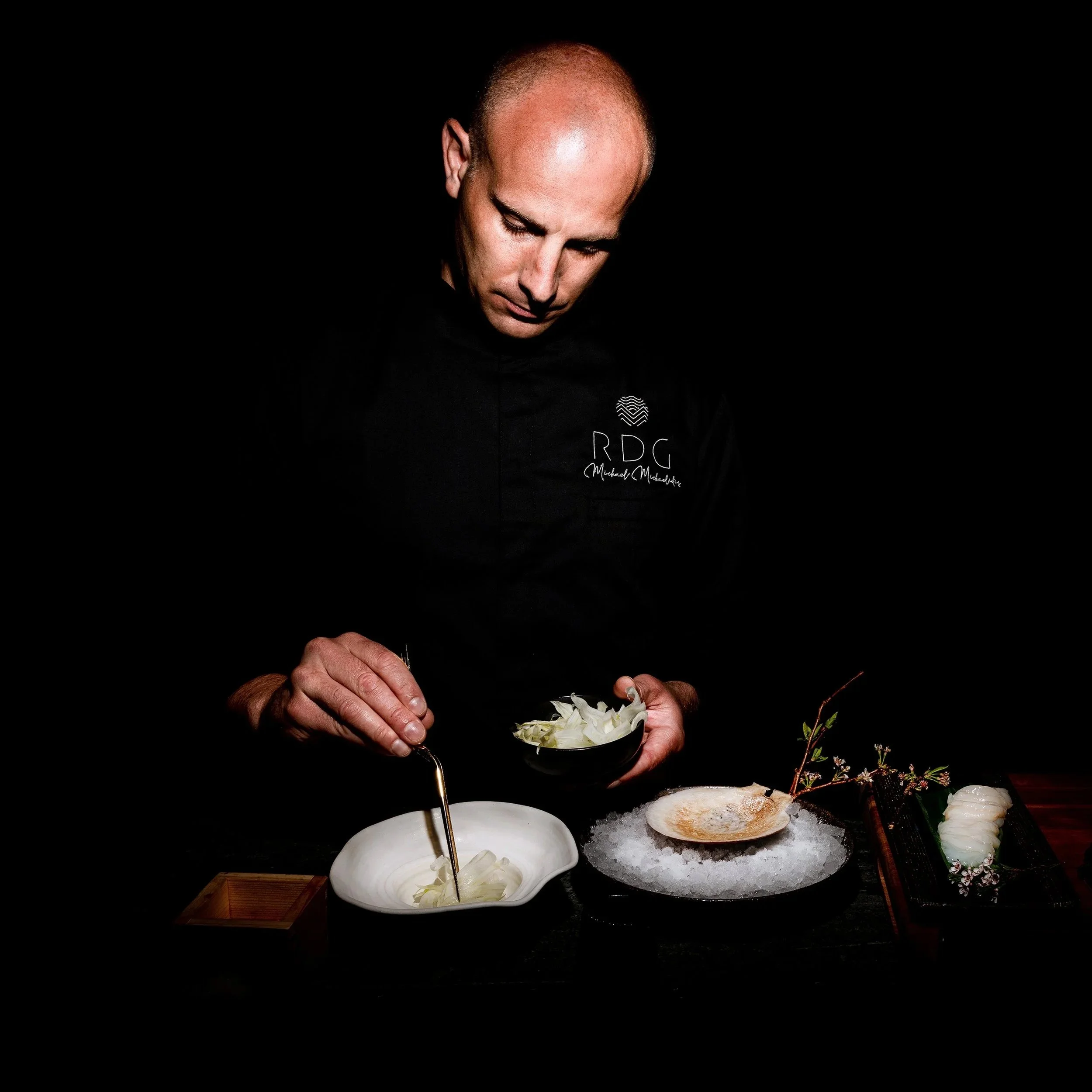 Chef Michael preparing an elegant dish at one of Riviera Dining Group's venues.