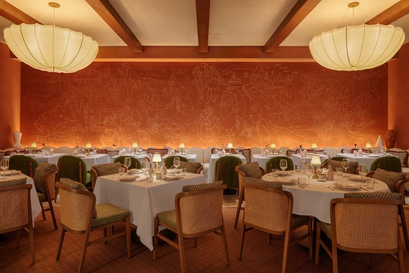 One of CLAUDIE's dining room areas, with circular and square tables.
