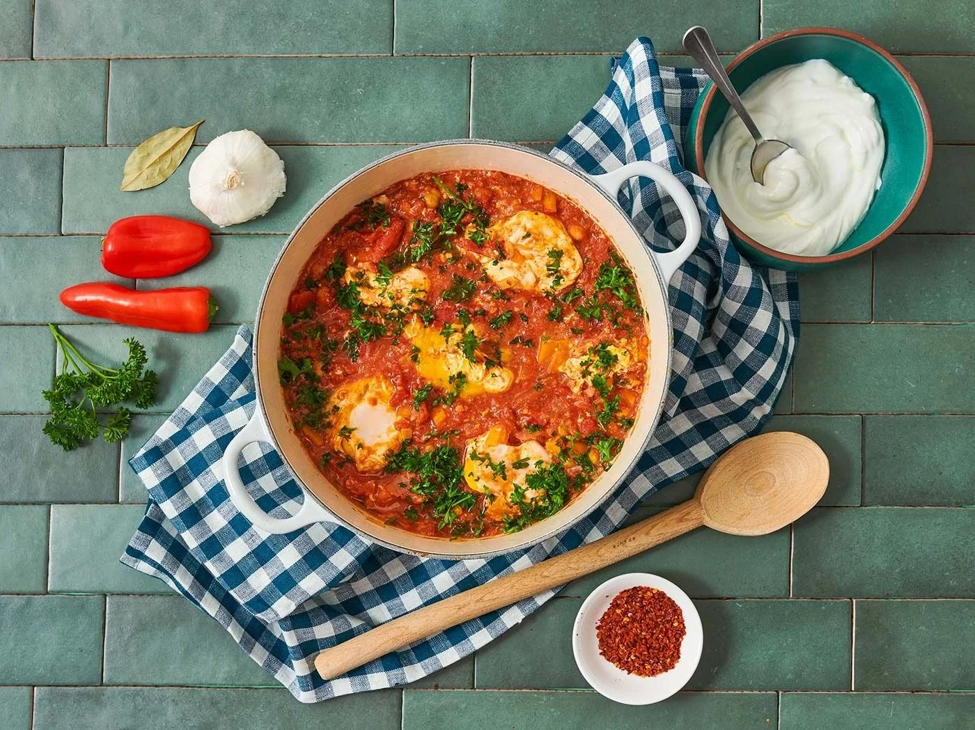 Edible Denver shakshuka in a cast iron pan, editorial food photography
