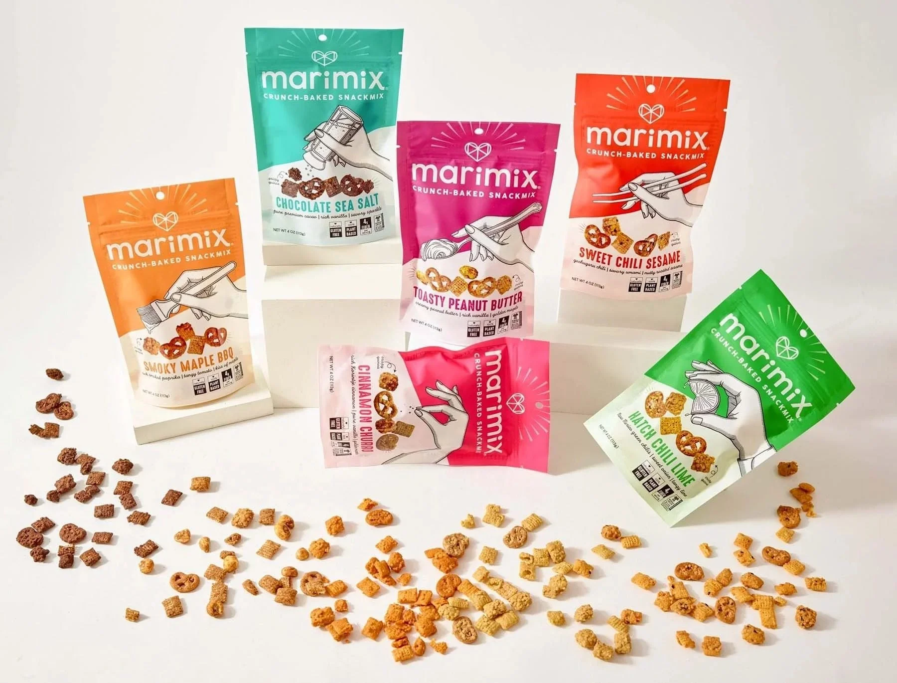 Marimix snack mix bags lineup with scattered snacks, CPG snack packaging photography