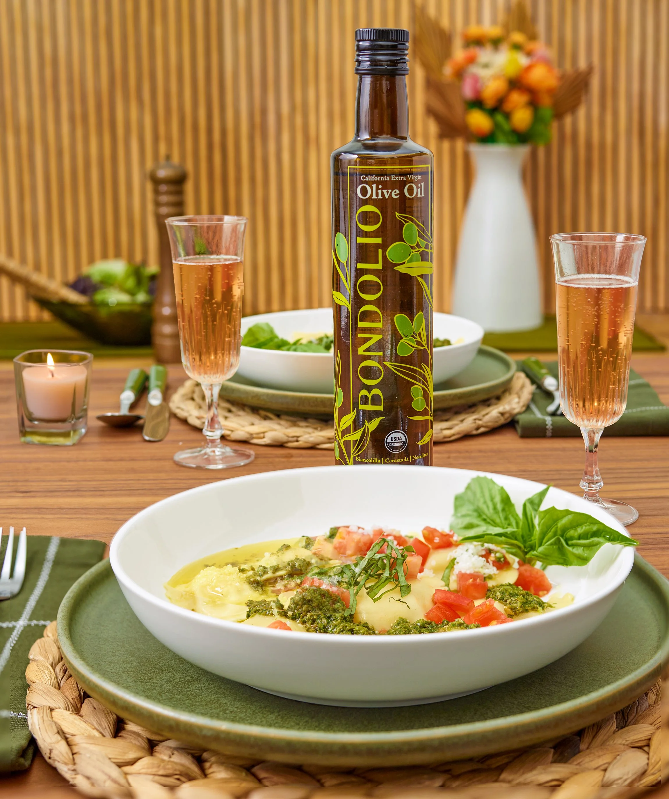 Date night pasta table with photo of cpg olive oil bottle in lifestyle set