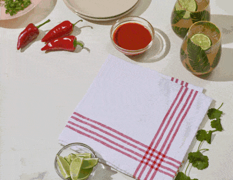 Stop motion GIF of enchiladas being assembled. Animated Mexican food recipe content.