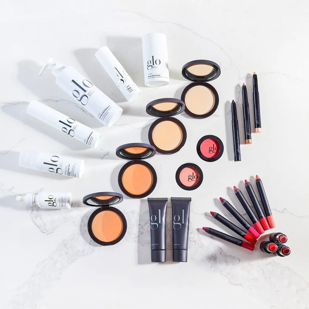 Makeup collection laid out on white, beauty product photography