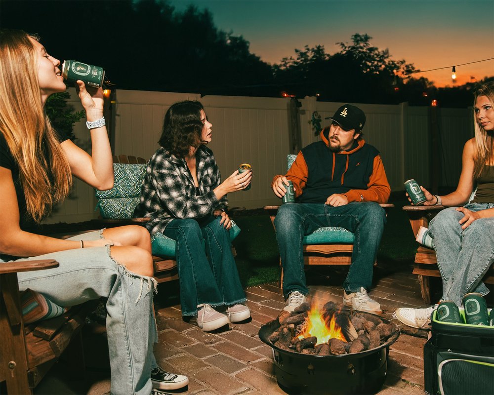 Friends around a backyard fire pit at dusk