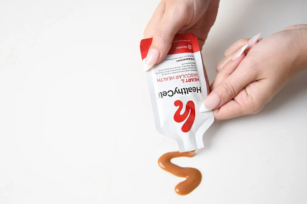 Hand squeezing Healthy Cell gel, supplement photography