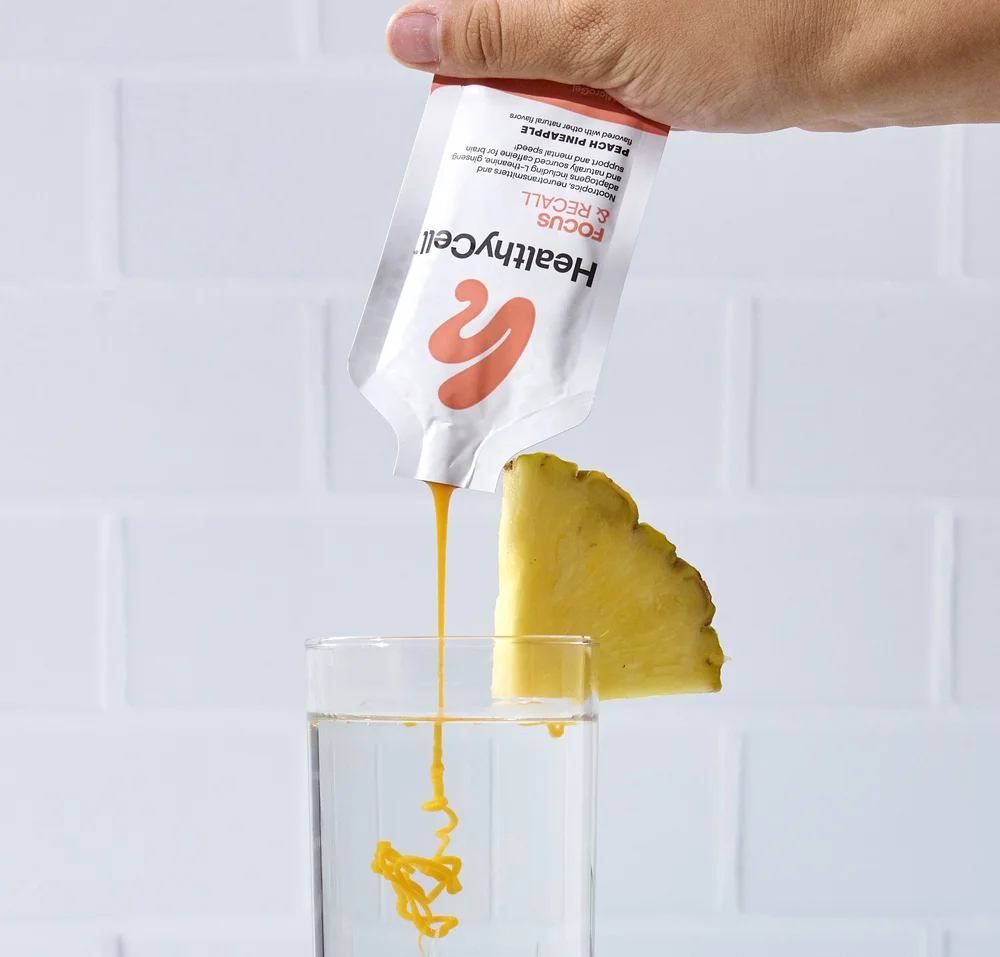 Pineapple peach gel pouring from a packet, supplement photography