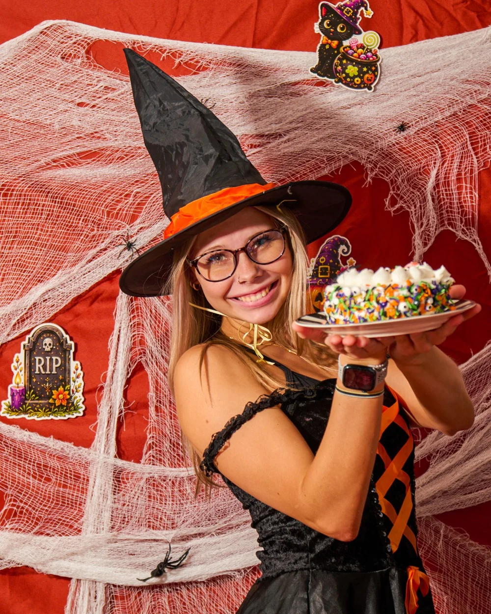 Witch holding a cake on a Halloween set