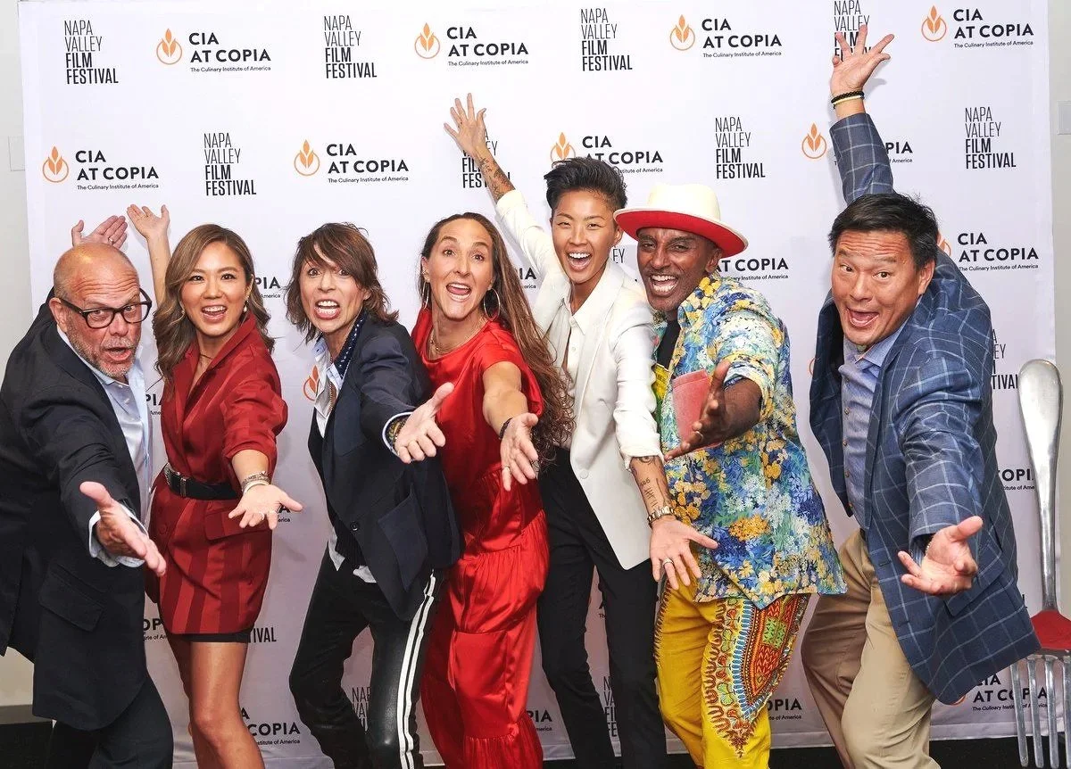 Iron Chefs posing with arms out at a Culinary Institute of America at Copia event in Napa, restaurant event photography with celebrity photos