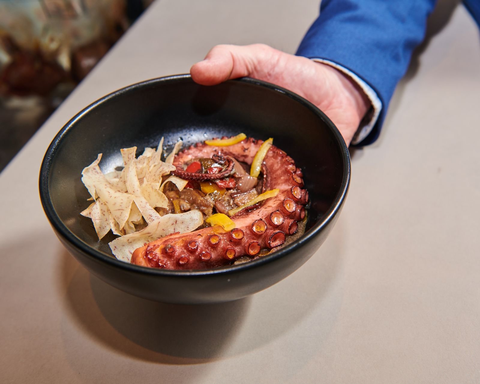 Octopus dish held by a server at a CIA at Copia event
