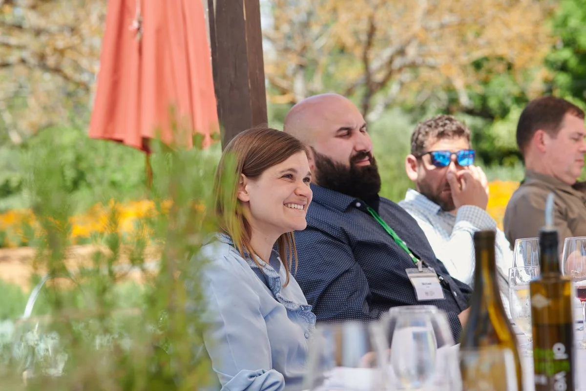 Smiling guests at a lunch table