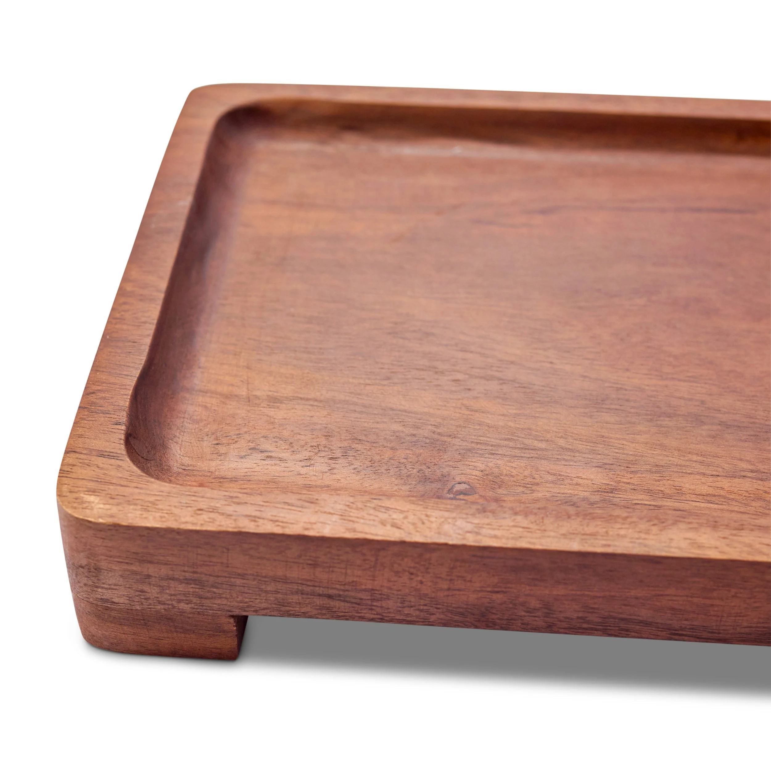 Close-up of a wooden tray with a smooth finish and rounded edges.