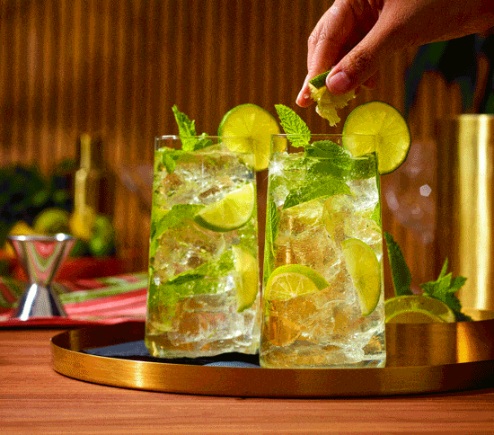 Lime mojitos with mint served on a gold tray, beverage stop motion