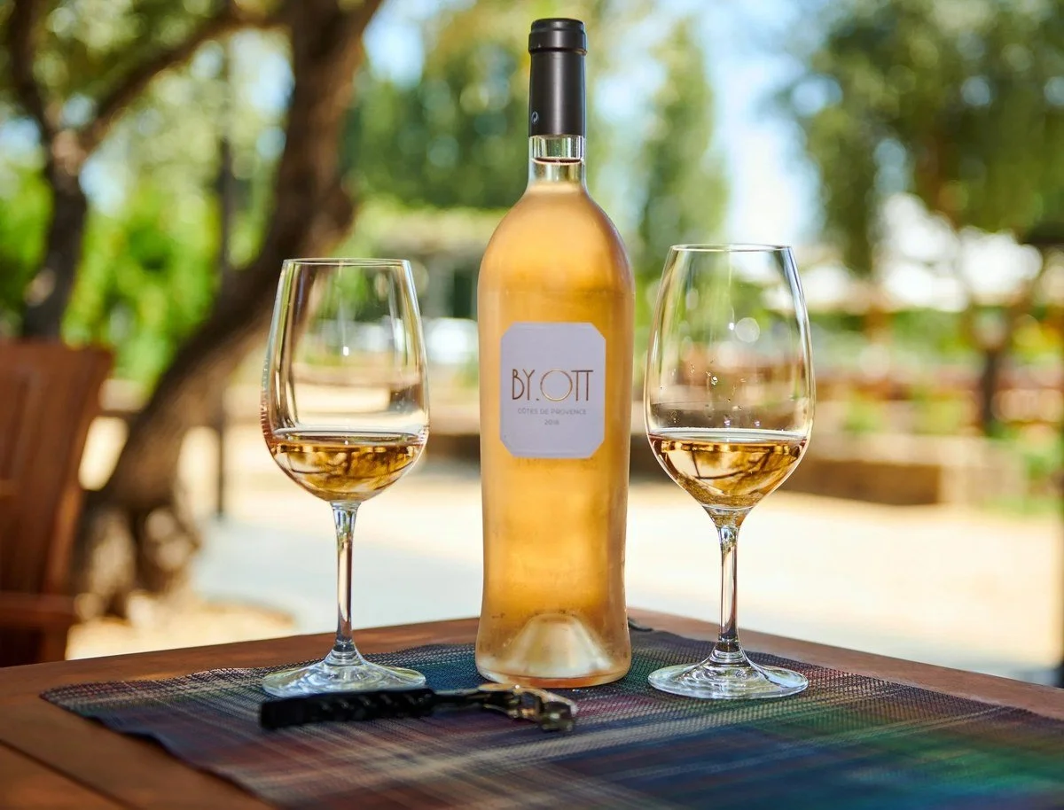 Rosé wine bottle and glasses on an outdoor table