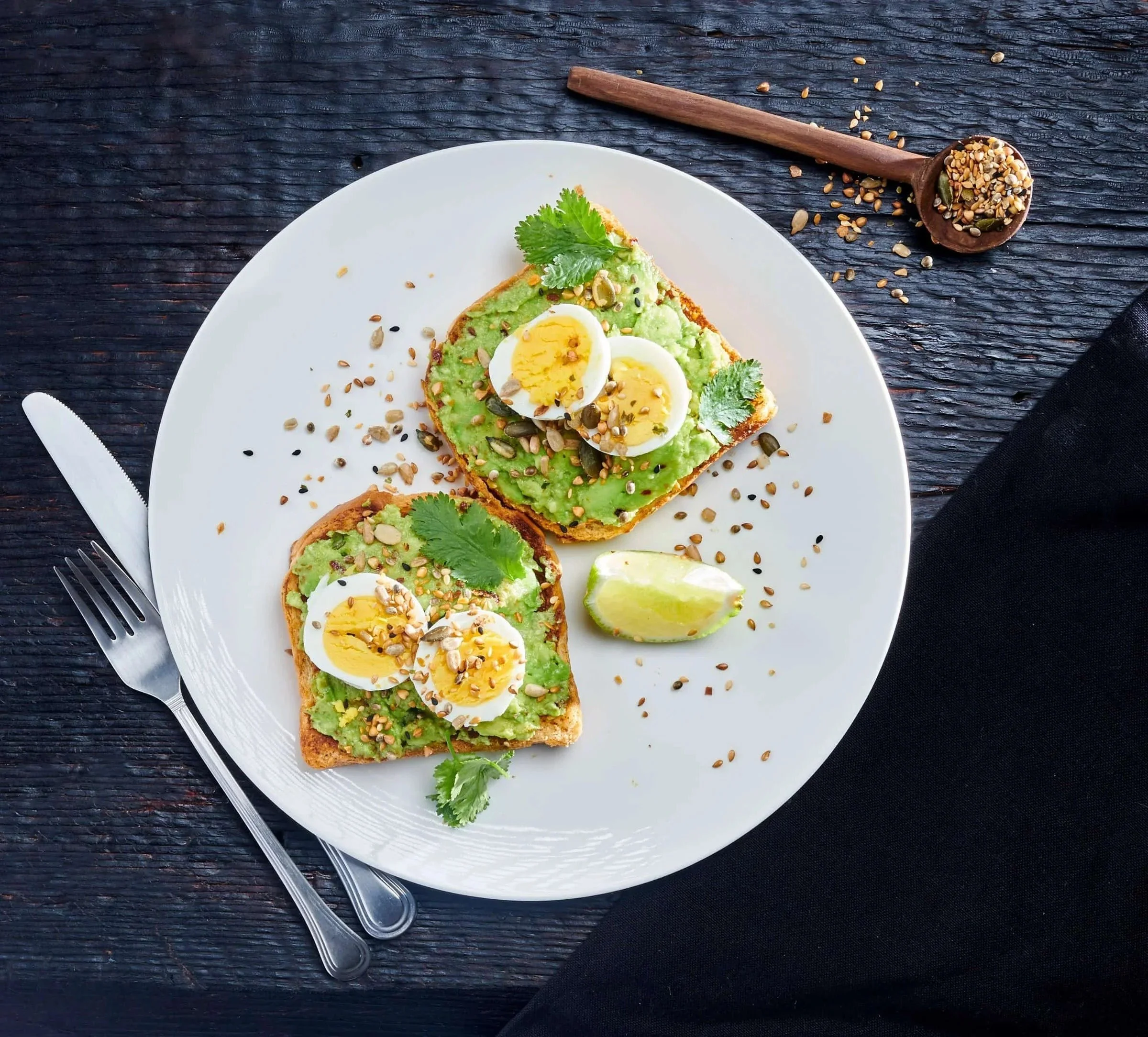 Food styling: avocado toast with soft eggs and seeds