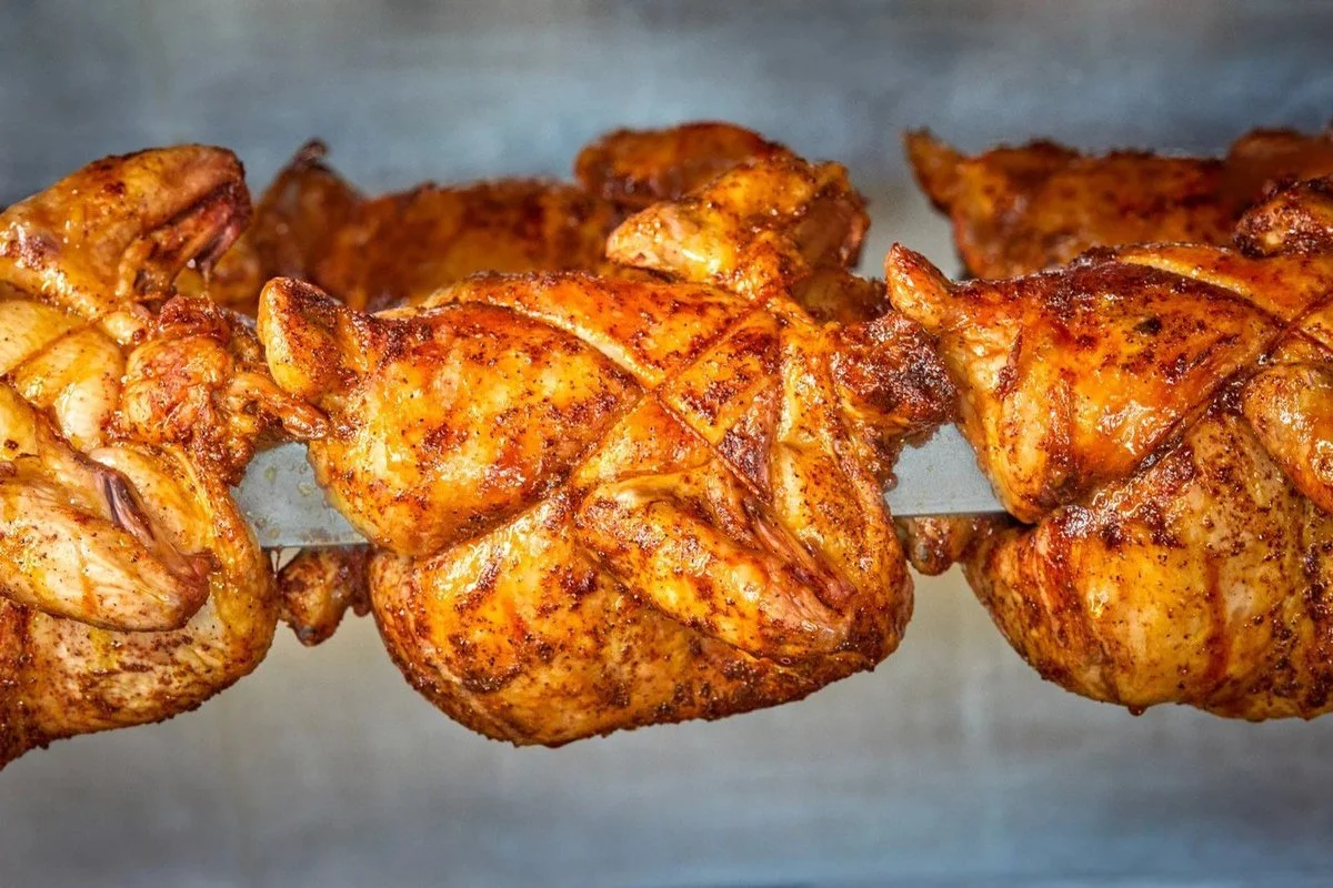 Rotisserie chickens turning on the spit