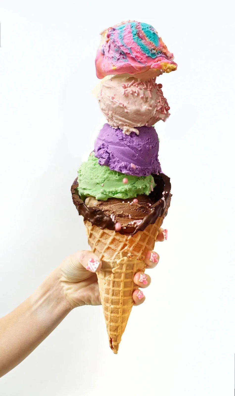 Food styling: four scoop ice cream cone held in hand