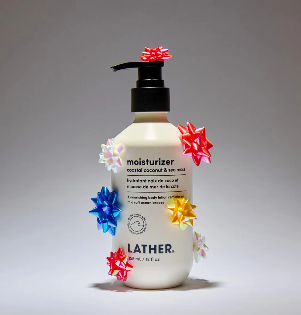 A white bottle of moisturizer decorated with colorful bows.