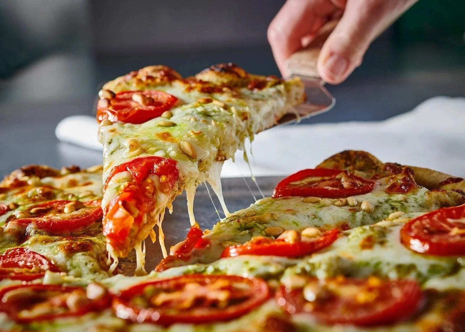 Food styling: pizza slice with cheese pull