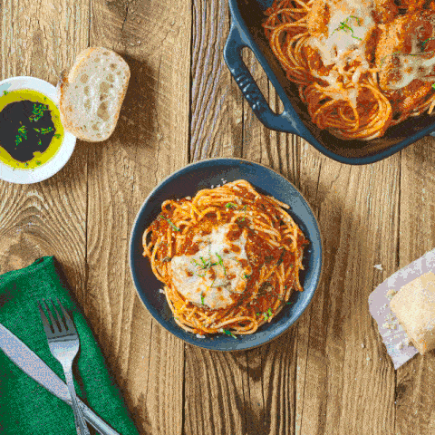 Stop motion GIF of chicken parmesan over pasta. Animated recipe content for brands.