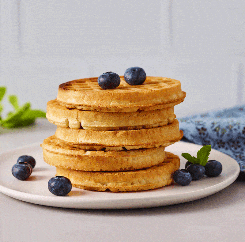Maple syrup drizzling over a pancake stack with blueberries, food stop motion