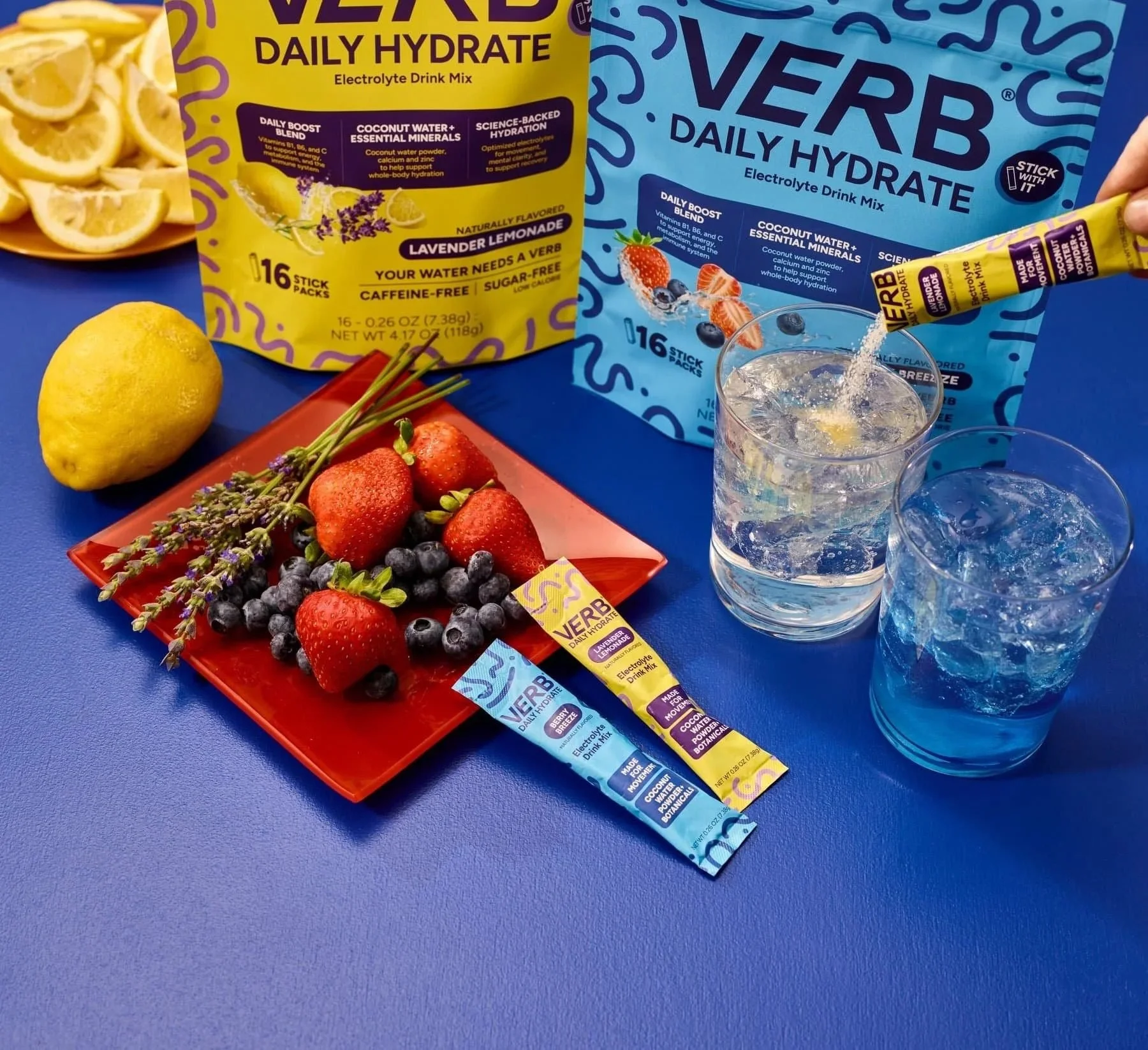 Verb Daily Hydrate electrolyte drink mix packs and drinks on blue, CPG hydration photography