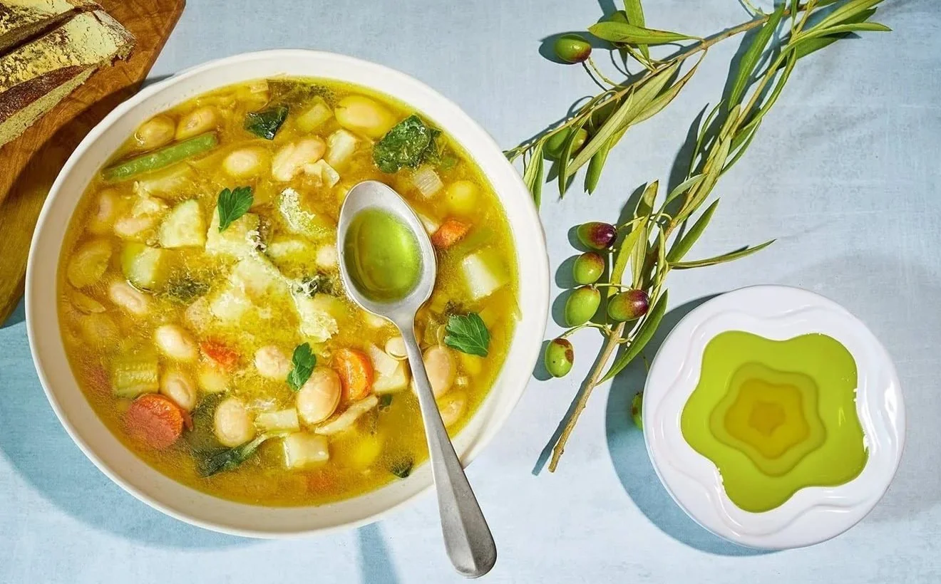 Bean soup with a drizzle of olive oil on a light blue background. Healthy food and soup photography.