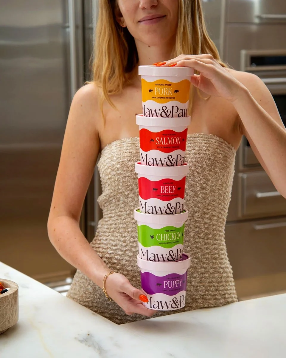girl holding cpg packages of human grade dog food lifestyle photo