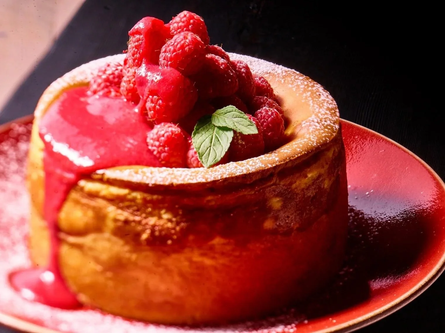 Raspberry topped cake with glossy red glaze. Dessert and pastry photography.