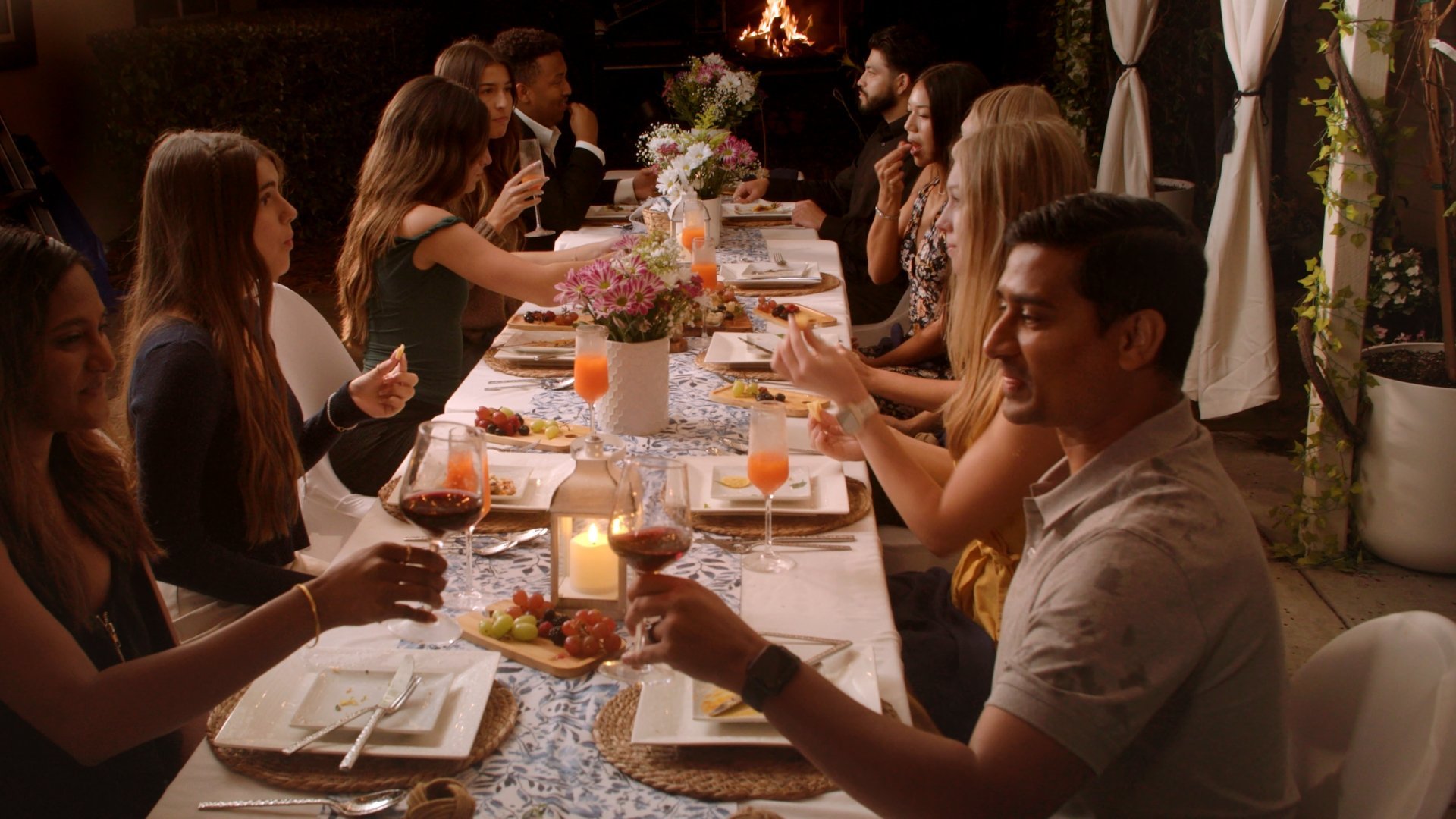 Candlelit long dinner table with guests at Casa Sarria, cinematic restaurant photography with natural shadows