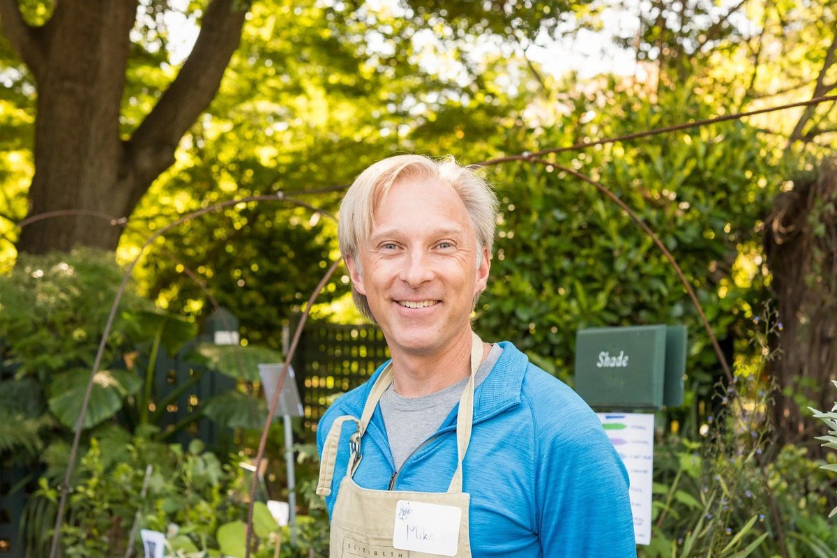 Smiling garden volunteer in an apron