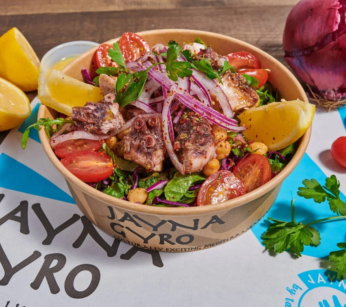 Close-up of an octopus salad in a takeout bowl